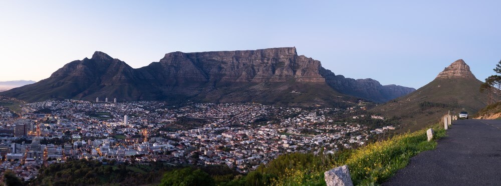 landscape showing table mountain and lions head with the city below in cape town